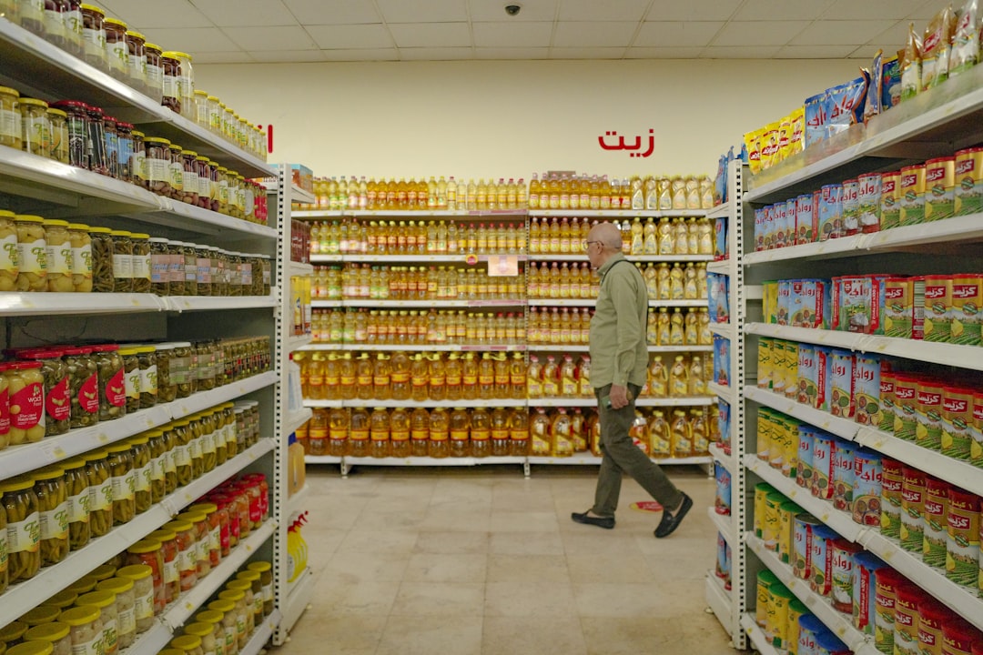 A man is walking through a grocery store aisle