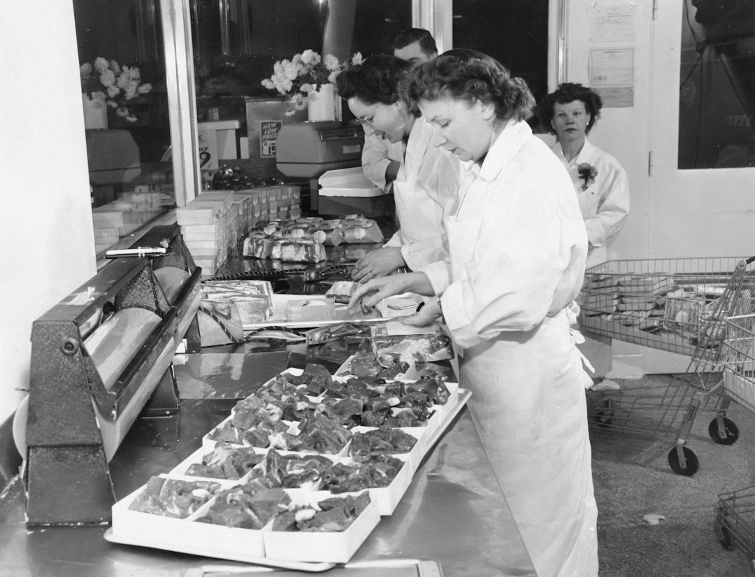 Workers arranging food in a market display