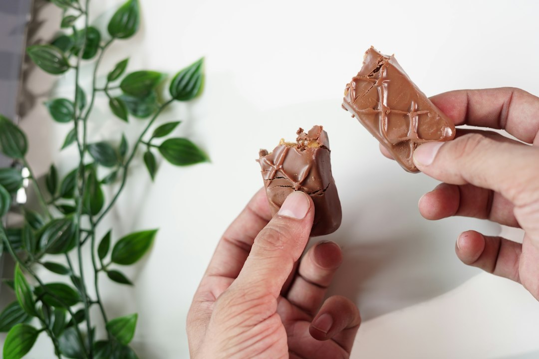a person holding a small brown object
